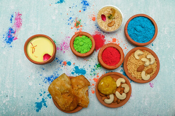 top view of colorful traditional holi powder in bowls isolated on dark background.Space for text . happy holi.Concept Indian color festival called Holi