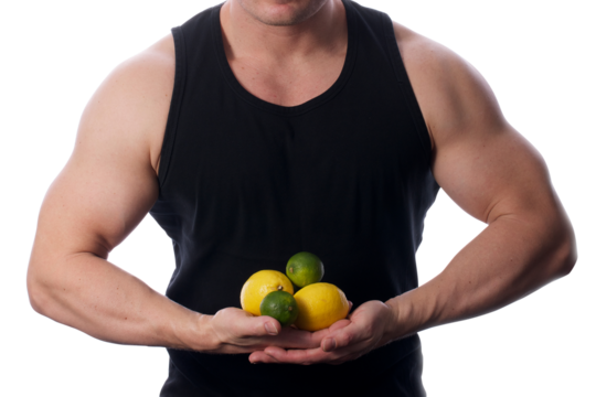 Strong fit muscular male holding lemons and limes in front of him transparent PNG