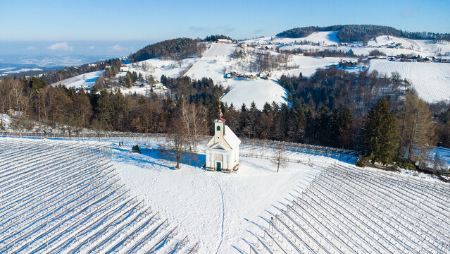 Chapel on a hill surrounded by a vinery in Austria during winter