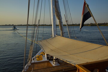 Sailing ship "Dahabeya" pulled by a motor boat on Nile, Egypt, Africa
