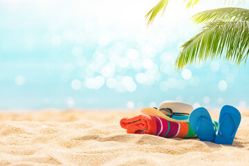 Summer holiday background with flip flops and palm tree on sandy beach - obrazy, fototapety, plakaty