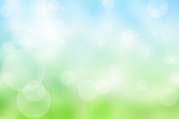 Fototapeta na wymiar Abstract nature blur background with bokeh light. Sunny spring meadow blur background, blue sky to green grass gradient