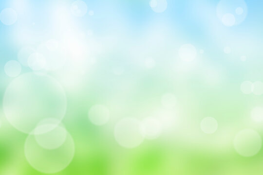 Abstract nature blur background with bokeh light. Sunny spring meadow blur background, blue sky to green grass gradient