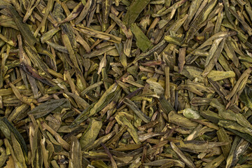 Close up Chinese green leaf tea. Dried tea leaves, top view. Macro