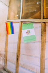 A rainbow flag and a Nigerian flag next to each other