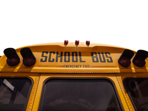 School bus emergency exit sign with cut out sky.