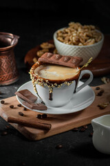 Obraz na płótnie Canvas Cup of coffee with chocolate on dark background