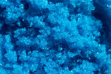 Fototapeta na wymiar Blue sugar body scrub background. Appearance of the texture cosmetic swatch. Skincare products. Beauty concept for face and body care.