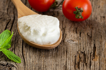 Homemade Yogurt with cream in a wooden spoon, healthy food