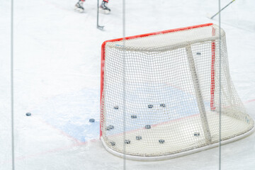 ice hockey goal with pucks, during a hockey players training session