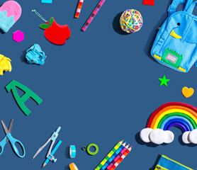 School supplies with a rainbow - overhead view - flat lay