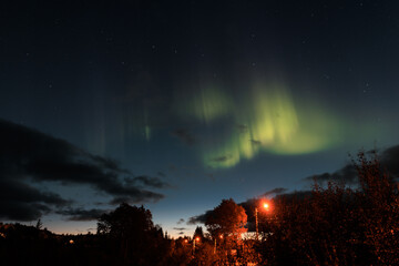 Fototapeta na wymiar Northern lights / aurora visible at night in Norway in the sky