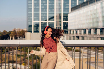 Graceful and Stylish Woman Spreading Joy and Positivity Through Energetic Dance in a Contemporary Urban Environment