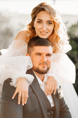 portrait of the bride gently embracing the groom. happy and loving newlyweds.