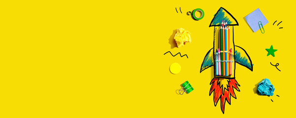 Back to school theme with a rocket with school supplies