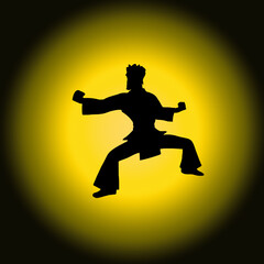 Fototapeta na wymiar The silhouette of a kung fu fighter, black and white shape from comics, cartoons or video games, over a yellow sphere of light as a background. Dynamic pose. 