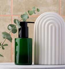 Green plastic bottle with dispenser. Container for cosmetics