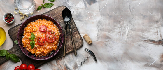 Plate with tasty tomato risotto on grunge background with space for text