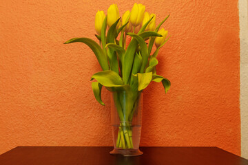 Bouquet of yellow tulips in a vase on a table