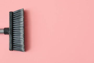 Fototapeta na wymiar Plastic cleaning broom on pink background