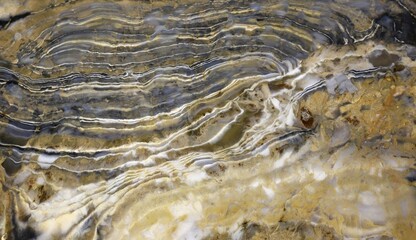 Texture of a colorful natural stone with layer structure as a background