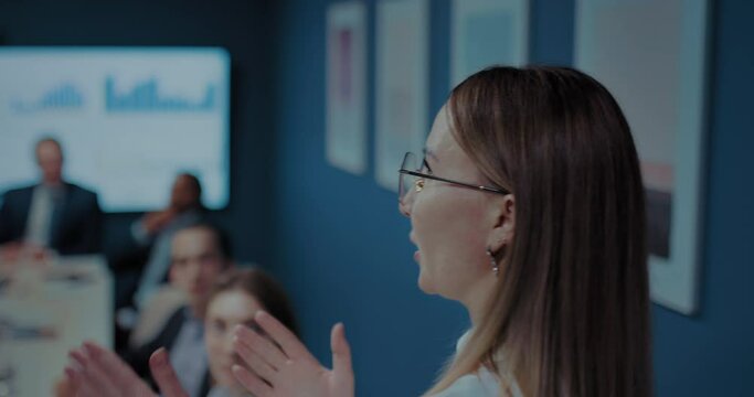 woman financial analyst speaking in business meeting with co-workers and partners, 4K, Prores