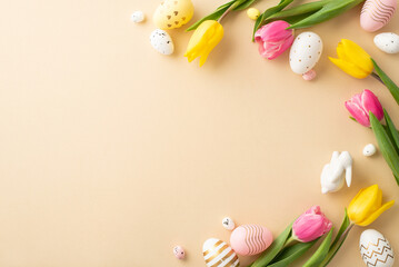 Fototapeta na wymiar Easter decorations concept. Top view photo of colorful easter eggs ceramic easter bunny and tulips on isolated light beige background with empty space