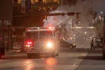Traffic in Baltimore with Vehicles and Fire Department Vehicle with Flashing Lights in Background.