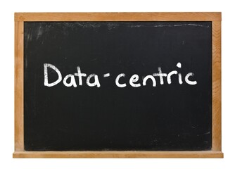 Obraz premium Data-centric written in white chalk on a black chalkboard isolated on white