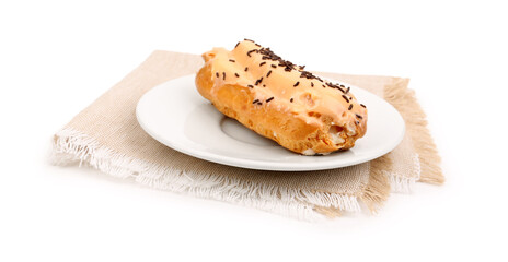 Plate with sweet eclair and napkin isolated on white background