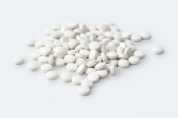 Heap of medicine white pills, antibiotic tablets, drugs. Pharmacy theme