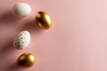 Image of multi coloured easter eggs and copy space on pink background