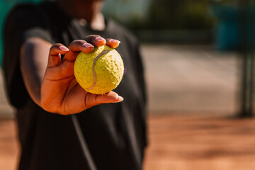 African american woman hold yellow green ball, playing tennis match on clay court surface on weekend free time sunny day. Female player ready to serve. Professional sport concept
 - obrazy, fototapety, plakaty