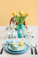 Beautiful table serving with painted eggs and tulip flowers served for Easter celebration