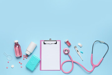 Obraz na płótnie Canvas Blank clipboard with medical supplies on blue background. World Health Day