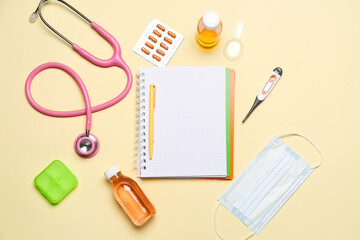 Fototapeta na wymiar Blank notebook with medical supplies on yellow background. World Health Day