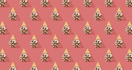 Pattern of hazelnut ice cream on a stick on pink pastel background
