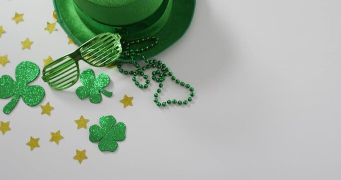 Shamrocks and stars with green hat and glasses with copy space on white background