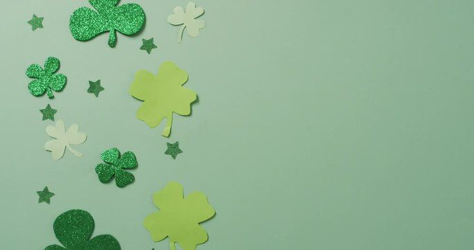 Shamrocks and stars with copy space on green background