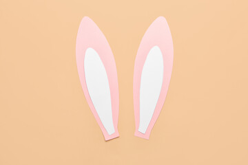 Paper bunny ears on beige background