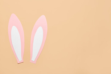 Paper bunny ears on beige background