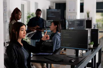 Concentrated web developer working with hologram and coding language in programming it office room. System engineer analyzing holographic script and augmented reality to develop new server interface.