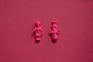 Abstract 3d figures of a pair of two woman as a conceptual graphic resource in monochromatic pink