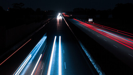 Stunning Long Exposure Photo of a Busy Highway, with many cars on the road and neon lights from the...
