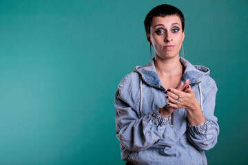 Satisfied brunette woman clapping hands and applauding successful achievement, celebrating big victory. Excited female doing applause gesture as congratulations standing over isolated background