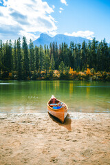 Canoe on shore at Two Jack Lake with view of Mount Rundle, Banff National Park