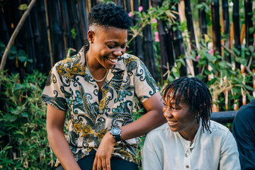 Queer masculine black women talking in a garden