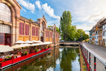  View from a wooden boat of the outdoor waterfront cafe at the Marché Couvert or covered market in thePetite Venice district of Colmar, France, in the Alsace region.