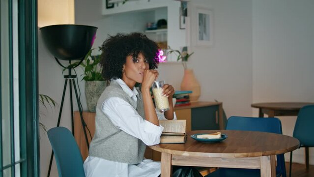 Lonely woman drinking cocktail alone sitting in cozy restaurant. Lady resting