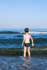 Fototapeta premium swim, learn to swim, child laughs, waves, splashes, ocean, danger on water